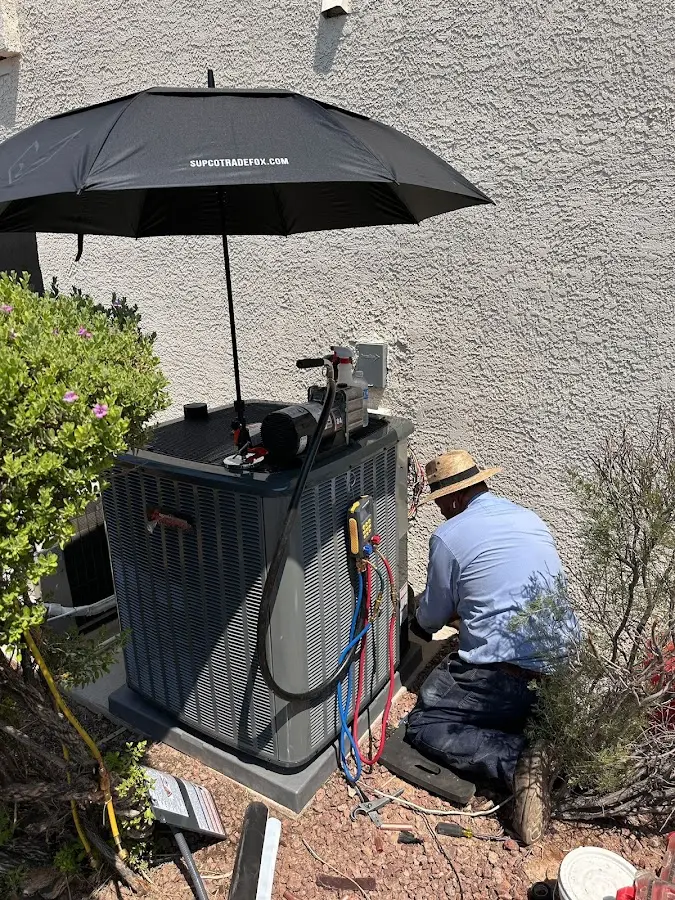 HVAC technician performing outdoor AC maintenance in Beach Park